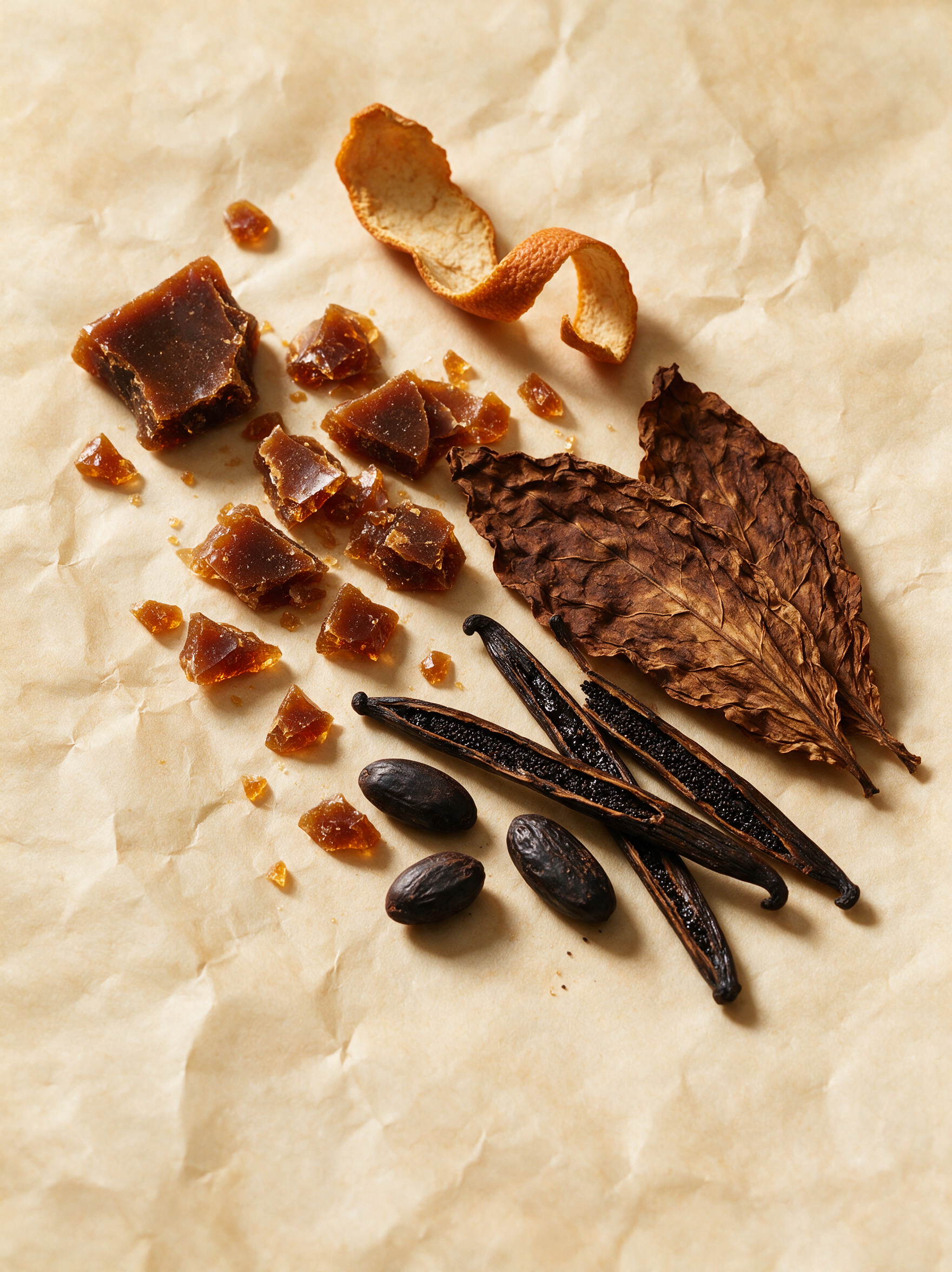 Caramelised sugar shards, orange peel, tobacco leaf, vanilla pods and tonka beans on parchment